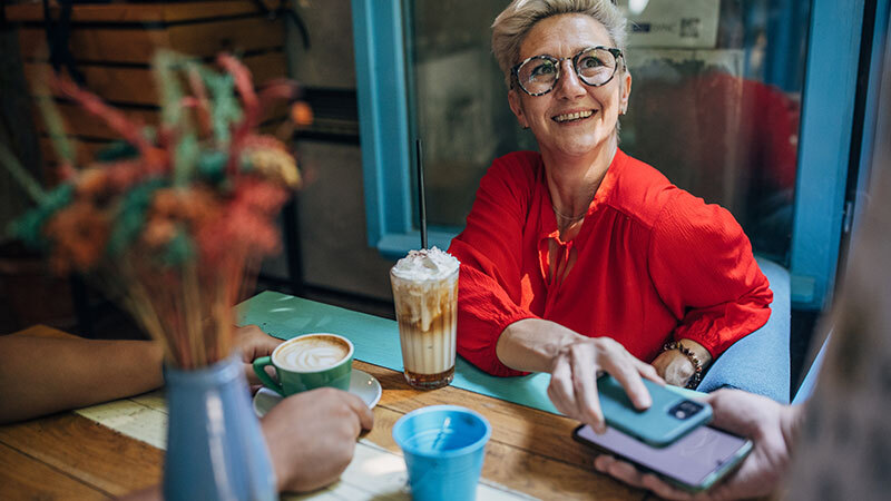 Woman paying with phone at cafe